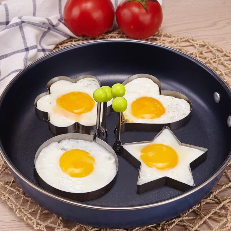 4 stainless steel egg ring molds in round, flower, star, and heart shapes.