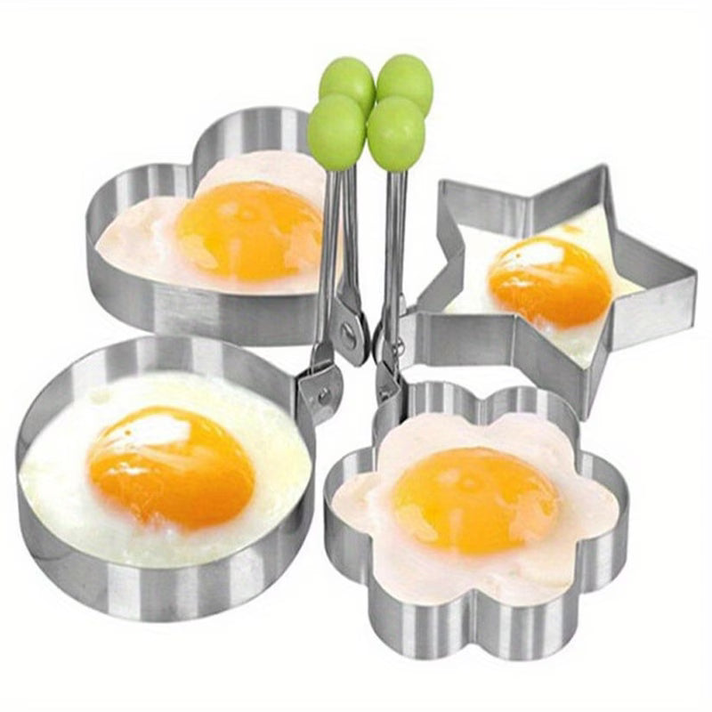 4 stainless steel egg ring molds in round, flower, star, and heart shapes.